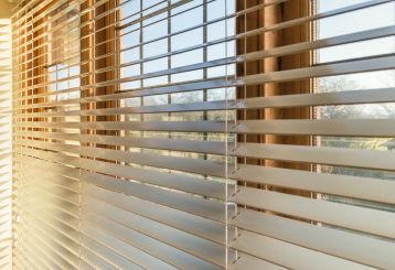 Faux wood blinds installed on modern living room windows